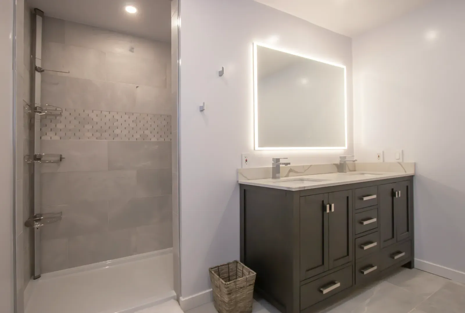 Remodeled bathroom with a double vanity and coordinated tile